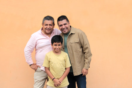 Three generations of a dark-skinned Latino grandfather, father, and son show their love and spend time together to celebrate Father's Dayの写真素材