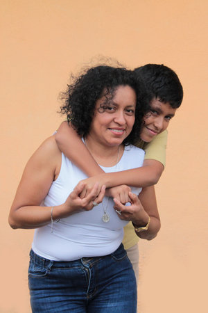 A single mother and her 9-year-old Latino son show their love with hugs and kisses to celebrate Mother's Dayの写真素材