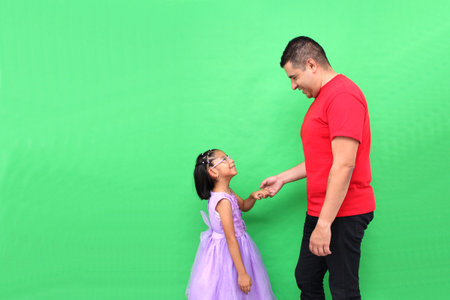 Single dad dances with his 5-year-old Latina daughter dressed as a princess to celebrate Father's Dayの写真素材