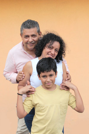 A Latino family of a father, mother, and 10-year-old son show their love and spend quality time...