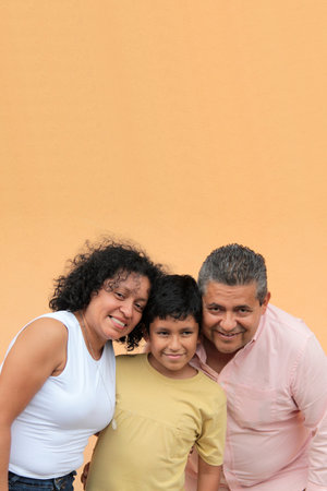 A Latino family of a father, mother, and 10-year-old son show their love and spend quality time together to celebrate Family Dayの写真素材