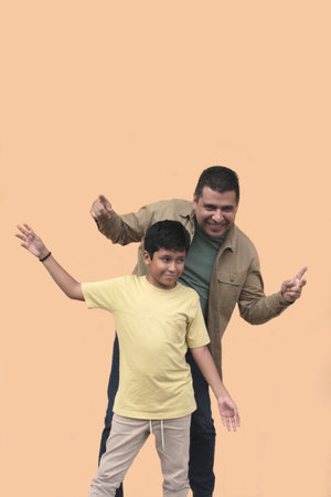 Single dad enjoys playing with his 10-year-old dark-skinned Latino son and spending time together to celebrate Father's Dayの写真素材