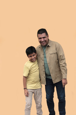 Single dad enjoys playing with his 10-year-old dark-skinned Latino son and spending time together to celebrate Father's Dayの写真素材