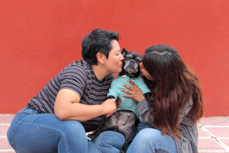 Couple of two brunette Latina lesbians show their love for the dog that is their pet and part of...