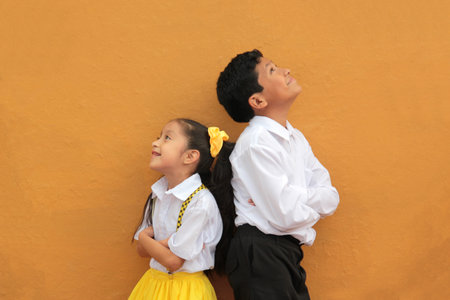 Latino older brother and younger sister play and tease each other during their free time on vacationの写真素材