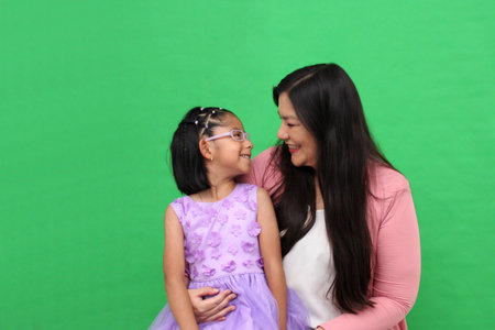 Divorced single mother plays with her 5-year-old Latina daughter, a brunette with glasses, spending...