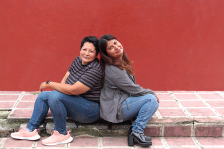 Couple of brunette Latina lesbians show their love and celebrate Gay Pride Day togetherの写真素材