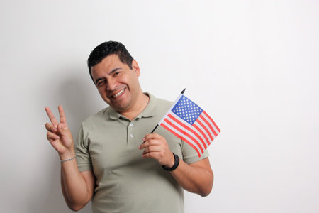 A 40-year-old dark-skinned Latino man displays the American flag and works to obtain citizenship
