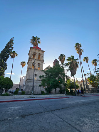 Cuatro Cienegas, Coahuila, Mexico - Jul 28, 2025: Cobblestone streets, park, and church in the...