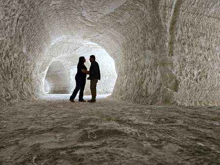Shadows of a man and woman couple backlit in chalk mines exploring and travelingの写真素材