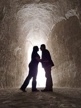Shadows of a man and woman couple backlit in chalk mines exploring and traveling to celebrate their anniversaryの写真素材