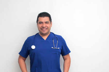 Dark-skinned Latino male doctor specialist with a stethoscope shows pride and success in his work for the health of patientsの写真素材