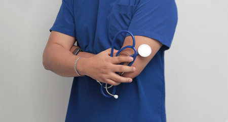 Dark-skinned Latino male doctor specialist with a stethoscope shows pride and success in his work...