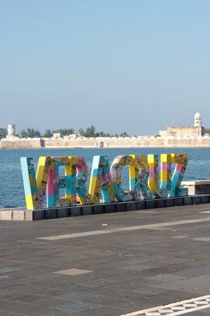 Veracruz, Mexico - Oct 26, 2025: Veracruz sign on the boardwalk of the commercial port with the sea...