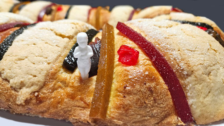 Rosca de Reyes is a traditional sweet bread decorated with crystallized fruits and hidden figures of...