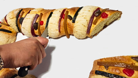 Rosca de Reyes is a traditional sweet bread decorated with crystallized fruits and hidden figures of...