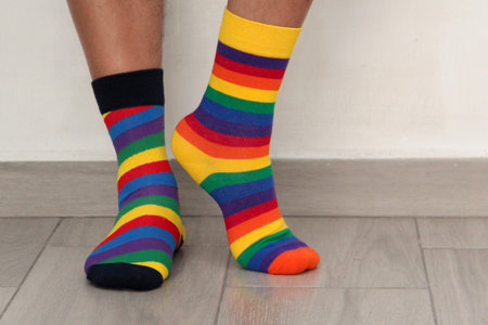 Feet with mismatched socks, different colors and designs for World Down Syndrome Day, to highlight...