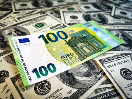 One hundred euro lies on dollarsの写真素材