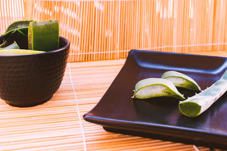 Photograph of aloe vera cut with bamboo background.の写真素材