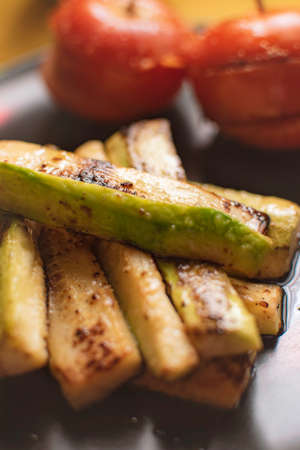 Vegetarian dish with eggplant cut into strips and two tomatoes.の写真素材