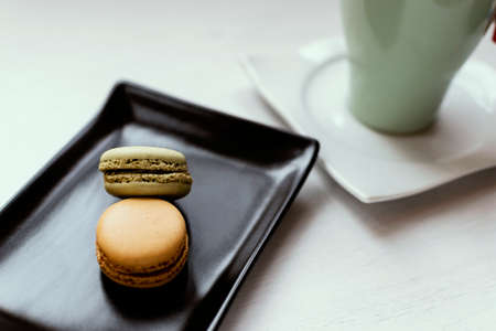 Photograph of macarons with a red tea cup.の写真素材