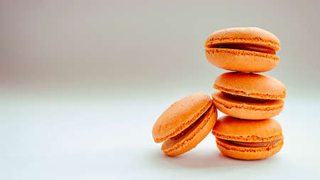 Orange oranges macarons, on a white background.の写真素材