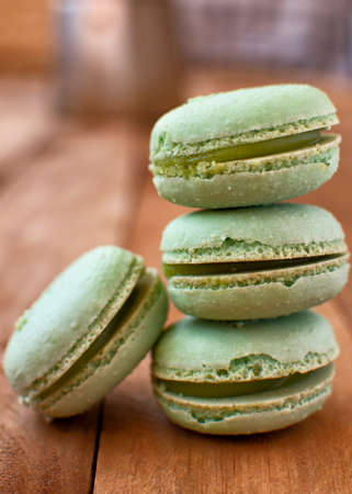 Melon macarons on a wooden table, with a vintage style.の写真素材