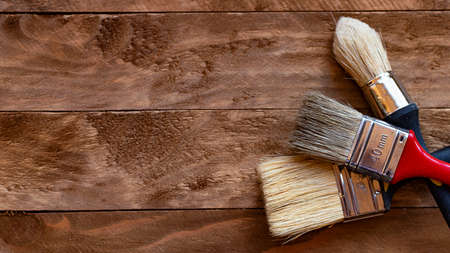Paint brushes on a wooden table, home do it yourself conceptの写真素材