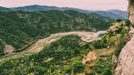 Mountain landscape with mountains in the background and a river located in the interior of valley.の写真素材