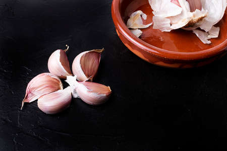 Cloves of garlic on a black vintage background.