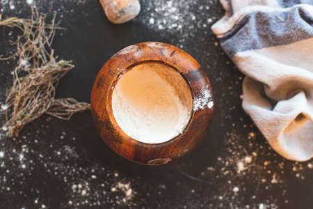 Bakery utensils such as flour, curlers and cloths on a rustic wood.の写真素材