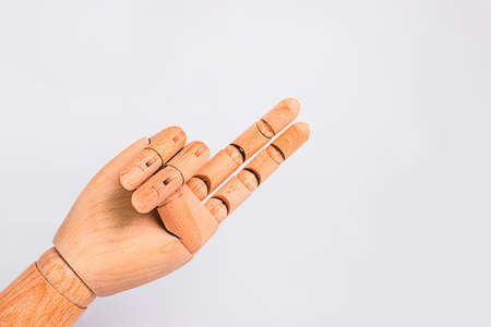 Wooden hand showing typical biker greeting, on a white background.の写真素材