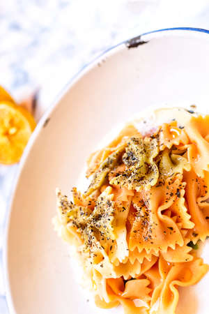 Plate of fresh colorful pasta dressed with oil. Mediterranean food concept.