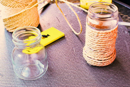 Work area in craft workshop with glass boats and scissors.の写真素材