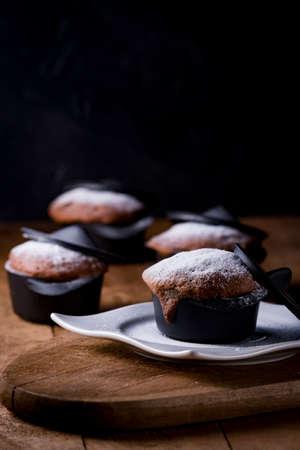 Brownie made in small black casserole on old wooden table.の写真素材
