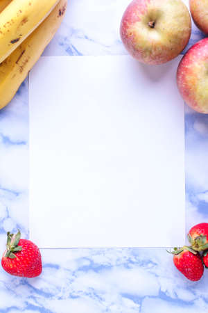 Invitation created with seasonal fruits and blue marble background.の写真素材