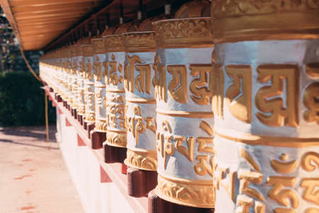 Group of golden prayer wheels typical of Buddhist temples