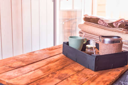 Breakfast in bed with unique touches that turn a house into a home, with a cup of milk and honey.の写真素材