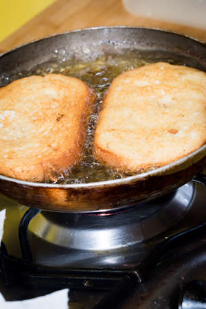 Frying bread to make a typical Spanish food, torrijas.の写真素材