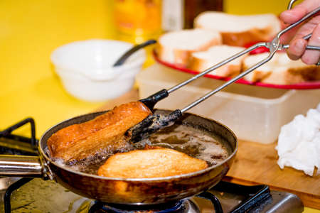 Frying bread to make a typical Spanish food, torrijas.の写真素材