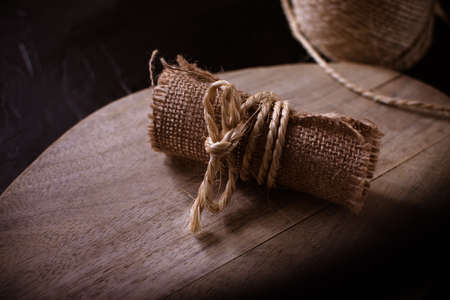 Hemp cloth and rope on wooden background