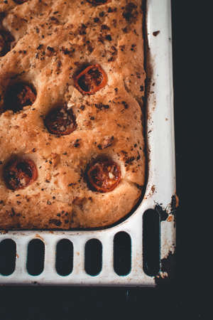 Traditional Italian homemade focaccia with tomato and oregano.の写真素材