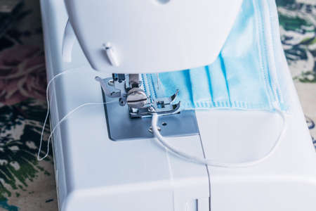 Sewing machine sewing masks for the COVID-19 pandemic.の写真素材