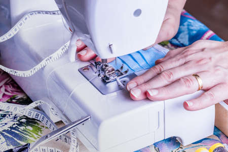 Woman sewing masks in the sewing machine for the COVID-19 pandemic.