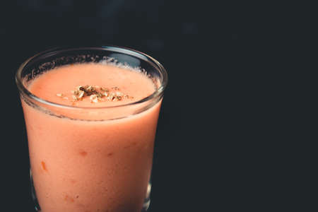 Andalusian gazpacho in shot glass with black backgroundの写真素材