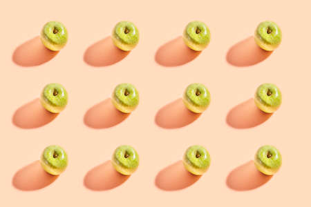 Pattern for repeating an image of a green apple with a pink background.