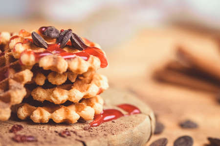 Mini waffles with strawberry syrup and chocolate shavings.の写真素材