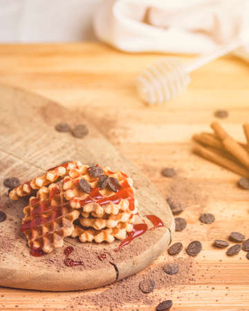 Mini waffles with strawberry syrup and chocolate shavings.の写真素材