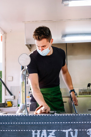 Food in a food truck. Man preparing food and utensils.の写真素材