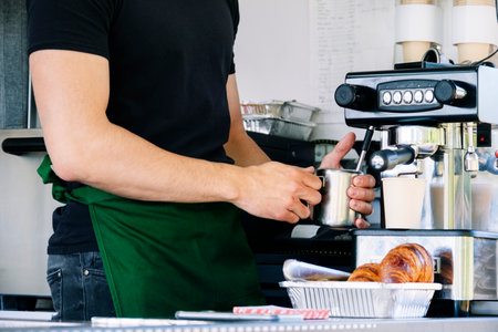 Food truck concept. Man preparing coffee in a small coffee pot.の写真素材